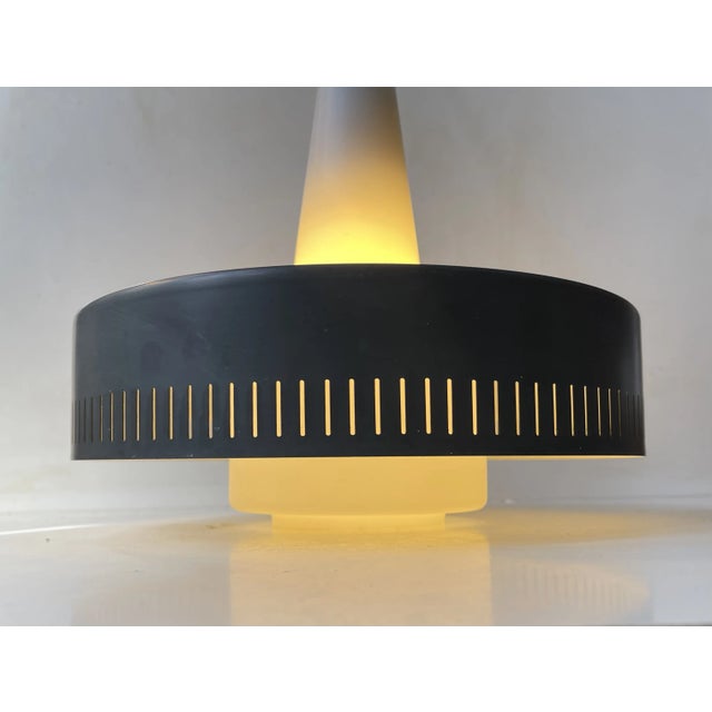 A rare lamp in the shape of this vintage 1960s pendant light by fog & mørup, denmark. It's a variation of jo hammerborgs...