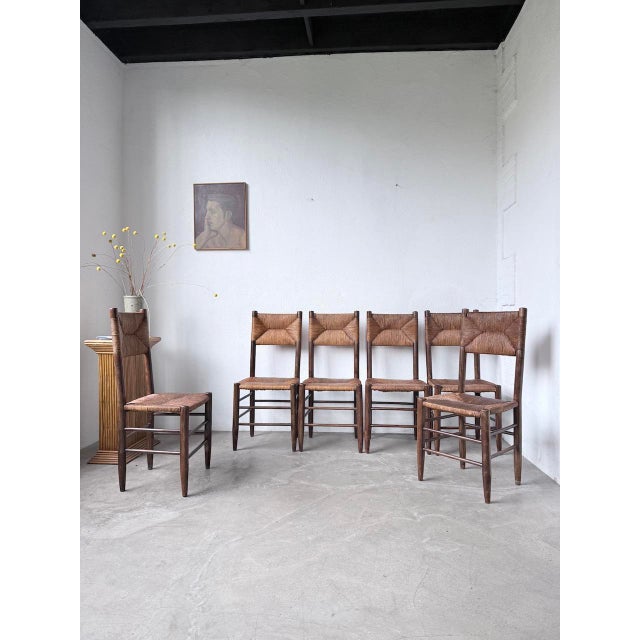 Set of six oak chairs with straw seats and backs. These chairs are reminiscent of Perriand's Beauche model. with their...