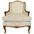An elegant vintage French Provincial Louis XV armchair featuring an exposed, carved wood frame with graceful cabriole legs...