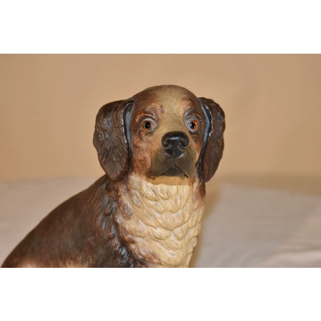 An exceptionally detailed 19th century painted terracotta dog from Austria. In a sitting position, it is hand painted with...