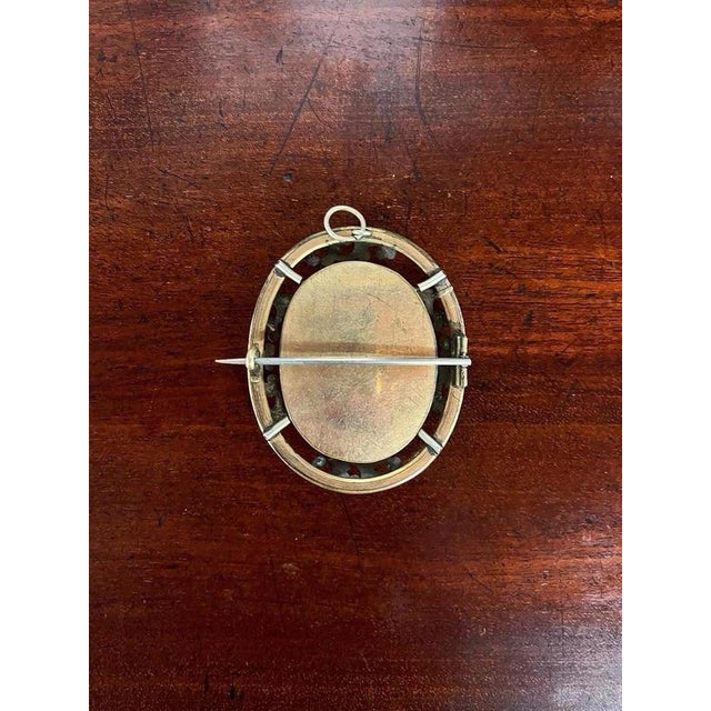 Victorian Mourning Brooch with Original Portrait, 19th Century Material: Gilt Metal, Glass, Photograph A beautifully...