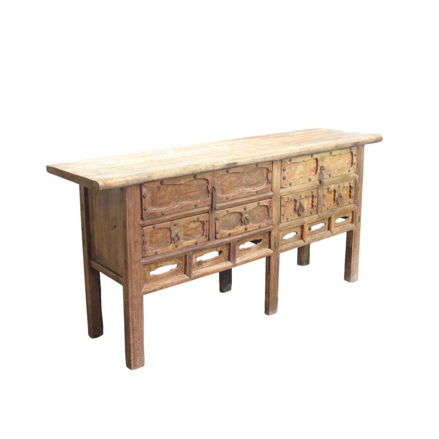 Dating to circa 1826, this antique Chinese sideboard has a beautifully rustic natural-wood surface shaped by approximately...