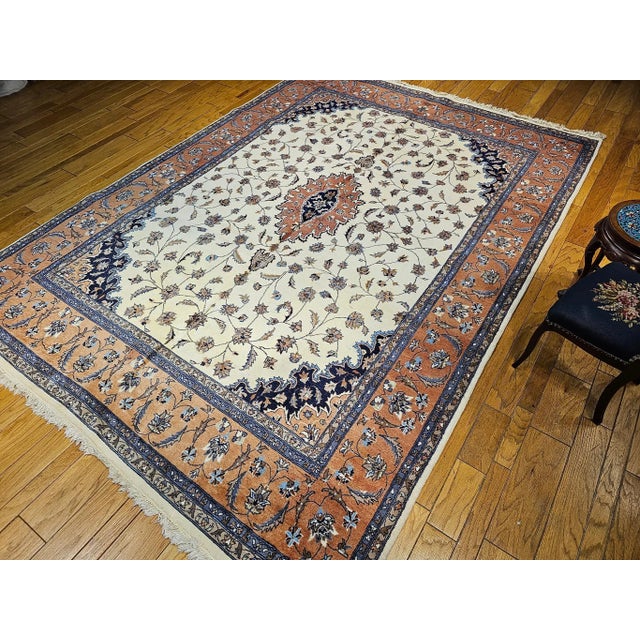 This beautiful vintage Tabriz design room-size rug, hand-knotted in the fourth quarter of the 1900s, features a timeless...