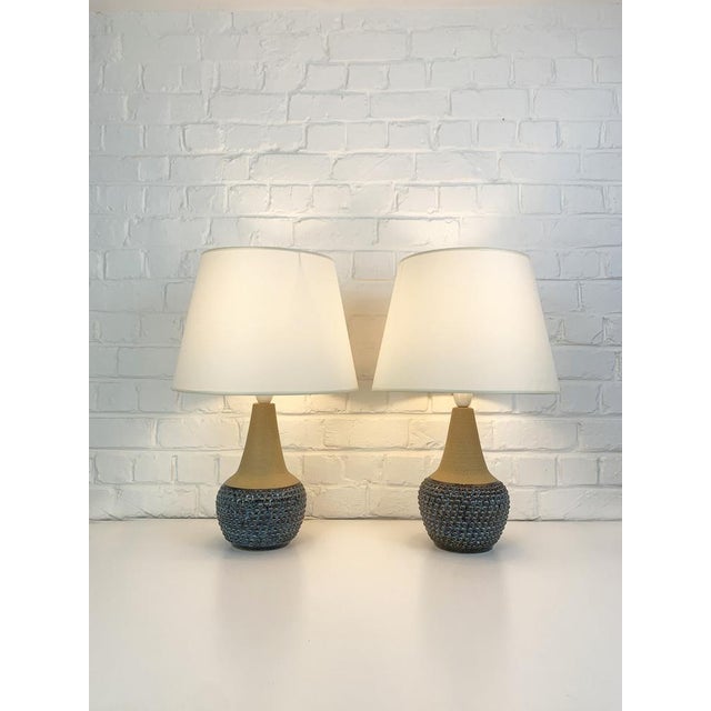 Pair Danish Mid-Century stoneware table lamps of the 1960-70s. The bottom part of the lamps is decorated with an impressed...