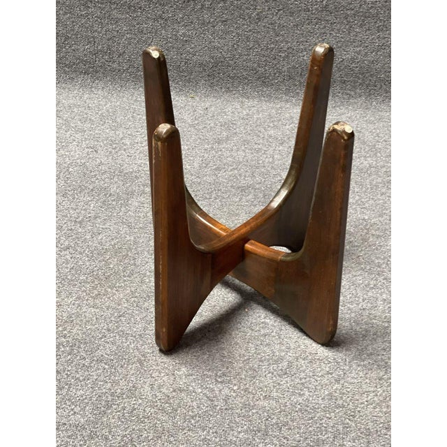 MCM side tables featuring a wood base and a clear glass top. The design includes intersecting wooden supports and a round-...