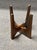 MCM side tables featuring a wood base and a clear glass top. The design includes intersecting wooden supports and a round-...