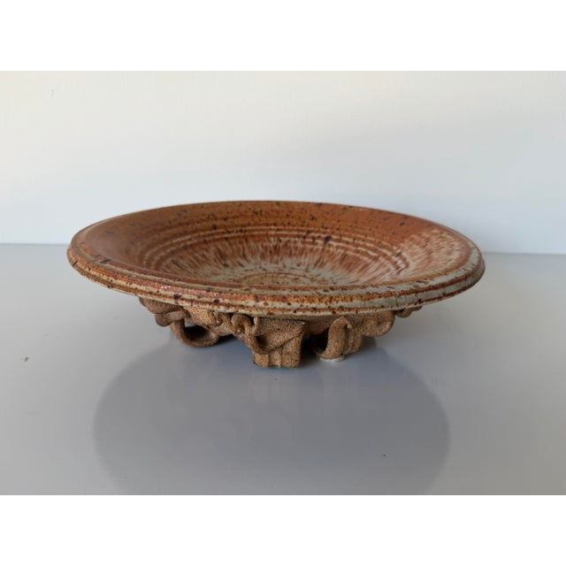 A striking 1980s studio pottery plate by Thomas Reece, showcasing the artist’s signature organic aesthetic and sculptural...
