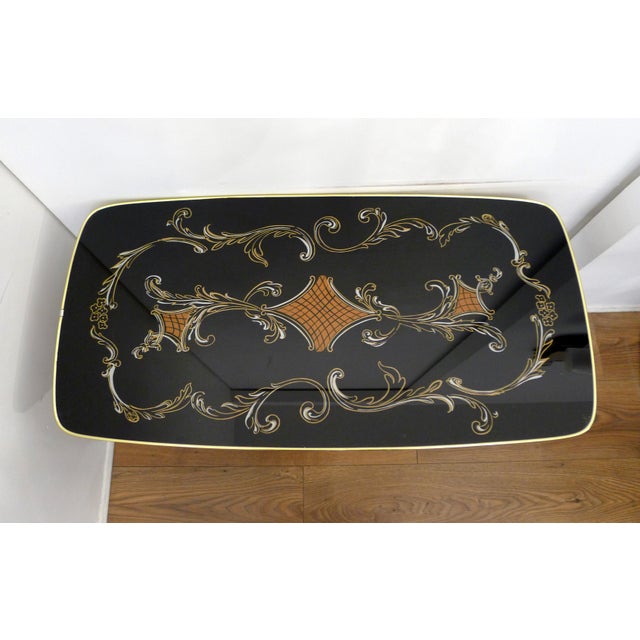 Large mid-century coffee table from the 1960s: slightly rounded rectangular shape, compass-style legs/tapered wooden legs...