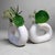 Pair of Japanese ikebana vases with a distinctly modernist design. Their soft oval ring shape and matte white surface...