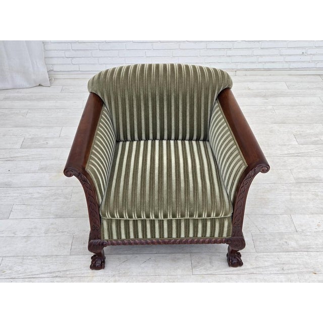1950s, Danish armchair. Striped green furniture velour, laqered teak wood, brass springs in the seat. The chairs were...