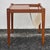 Simple and stylish, this Danish mid-century modern side table features a sleek magazine rack built into one side to keep...