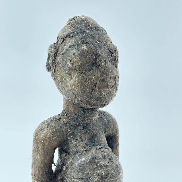 Experience the beauty and culture of Africa with our Kongo Fetish Figure from Congo. Hand-carved from pigmented wood, this...