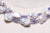 A double strand of large, white, baroque pearls with faceted tanzanite beads and 18K gold spacers. Blush baroque pearls...