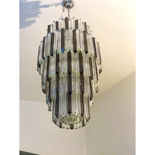 Luxury chandelier with clear and fumè "quadriedro" elements in Venini Style. Metal frame in chrome 9 bulbs D 60cm h 100cm...