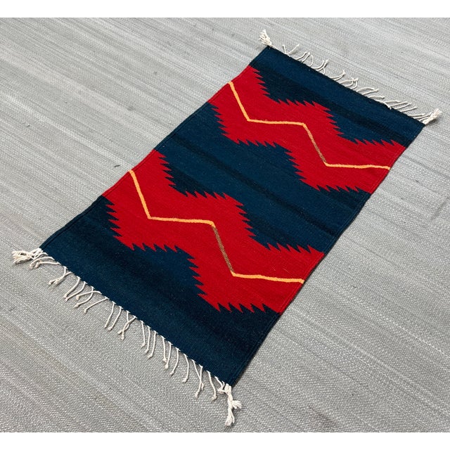 Design Plus Gallery presents a 1ft 11in × 3ft 7in Southwestern Flat Weave Zigzag Area Rug. The rug has a geometric design...