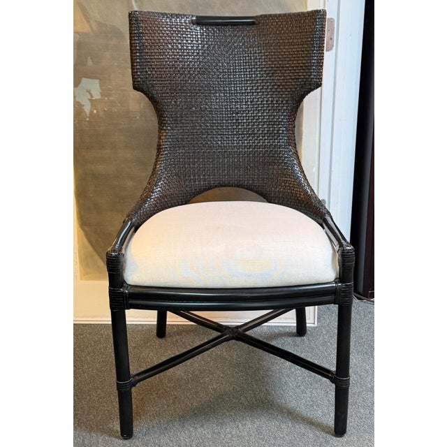 Design Plus Gallery presents the Caprice Armchair from Palecek. The chair has a pole rattan frame and legs with a double...