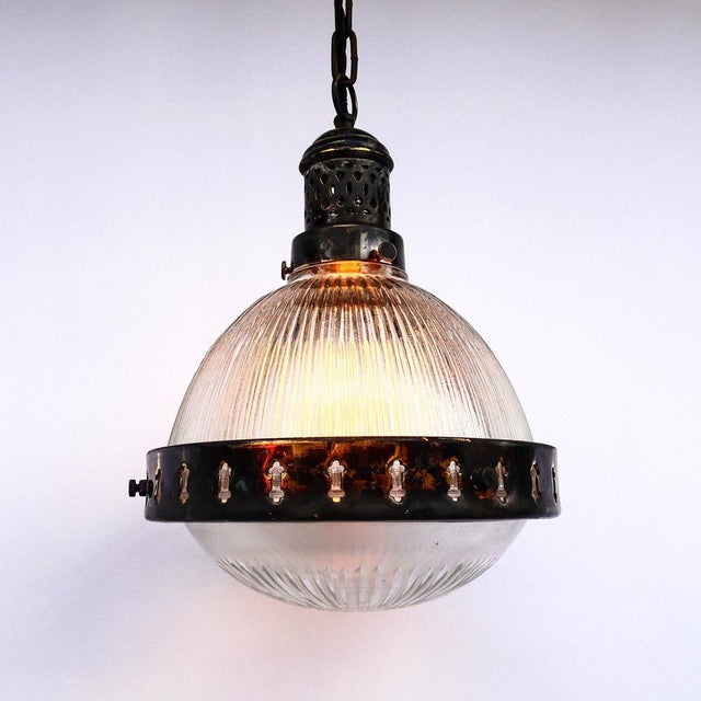Glass and brass pendant light, the top glass is ribbed and the bottom glass is cut, these two glasses perfectly diffuse...
