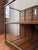 Authentic vintage mercantile store display case featuring a glass top and functional rear-access wooden pull-out bins....