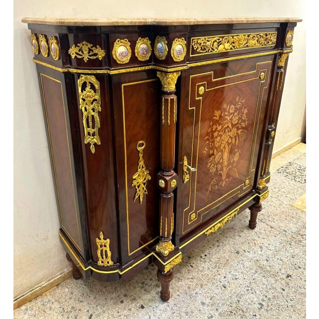 Introduce timeless French elegance into your home with this extraordinary Louis XVI-inspired sideboard cabinet,...