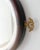 Antique Regency style oval wall mirror with a rich mahogany frame, beveled-edge glass, and decorative brass finial details...