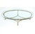 This MCM/ Hollywood Regency style brass and glass coffee table has a light and airy silhouette. Featuring stylized hoof...