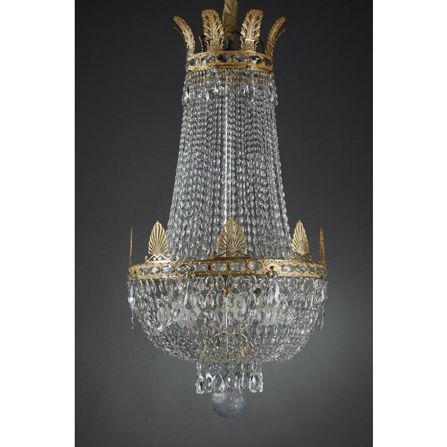 Large Empire-style hot-air balloon chandelier with tassels and ormolu mount with palmettes. It is lit by eight lights in...