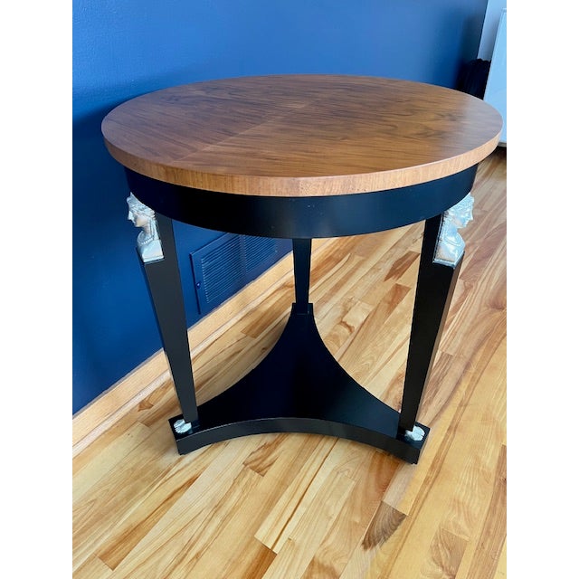 Elegant Neoclassical tripod pedestal table decorated with delicately carved busts and feet in the French empire style. The...