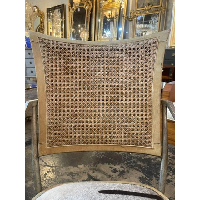 The Vintage Hollywood Regency Iron Chair with Cowhide is a stylish piece of furniture. This chair combines the classic...
