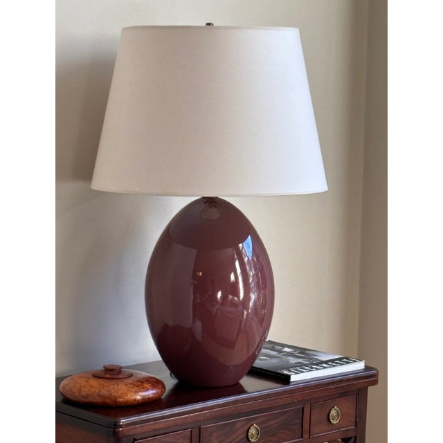 Looking for a pop of color? Offering a beautiful late-20th century egg-shaped ceramic table lamp in a glossy aubergine...