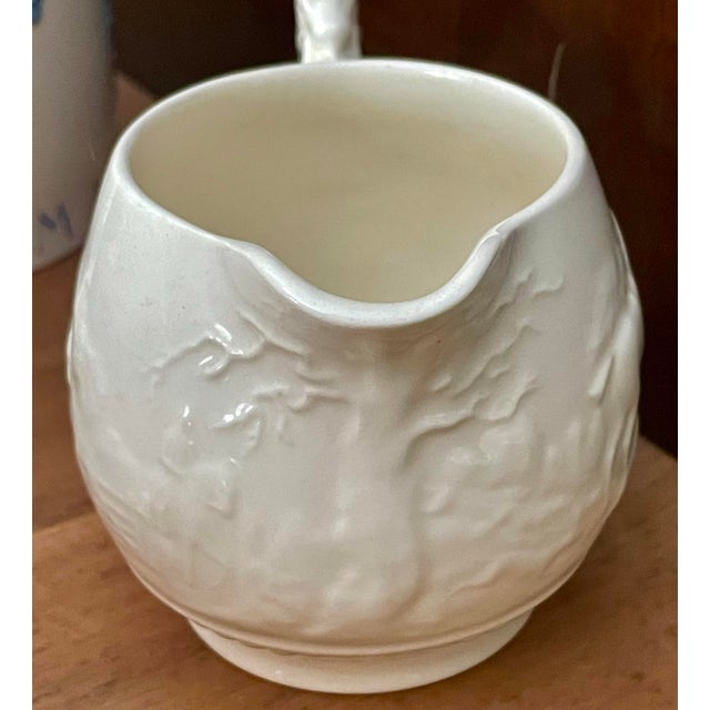 This is a sweet creamer or cream pitcher from Wedgewood's Devonshire line with an appealing hunting scene which is...