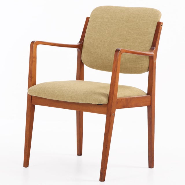 A refined set of eight open arm chairs dating to circa 1960, distinguished by their elegant mid-century form and clean...