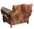 Impressive leather, and fur upholstered club and with studded nailhead trim, with matching footrest ottoman. The chair is...