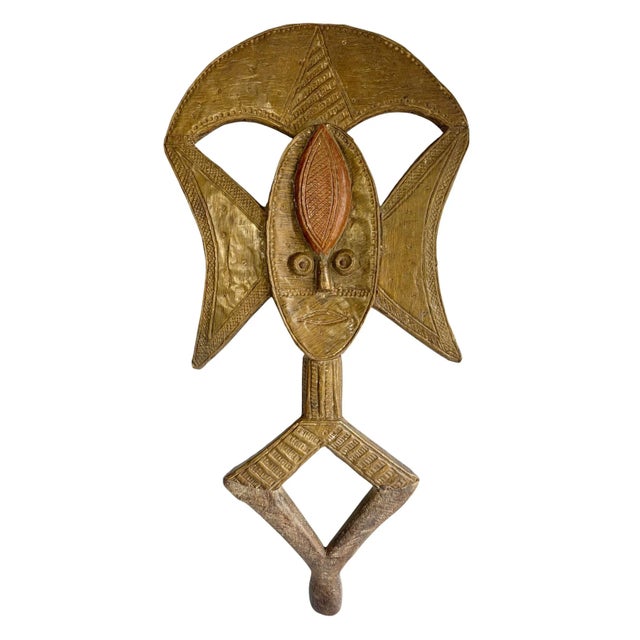 This exceptional Bakota reliquary figure from Gabon hand carved from a wooden armature sheathed in meticulously hammered...