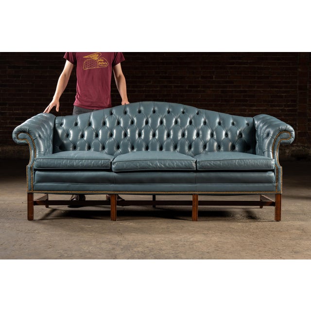 c. 1990s; Leathercraft, Inc. - Conover, NC A three-seat leather sofa in a classic Chesterfield form, upholstered in a rich...