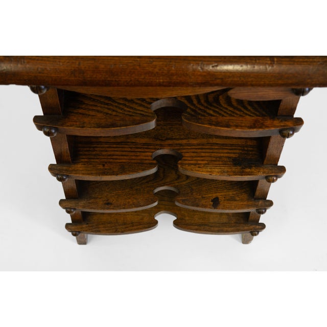 Unusual American Arts & Crafts oak paper rack shelves in the Charles Rohlfs manner. Circa 1900. Made in solid oak, the...