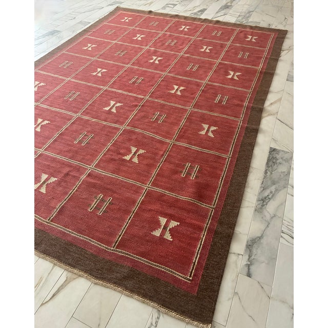 Beautiful large vintage Swedish Rug from circa 1940/50s. A red/pink base with a brown border and geometric designs in...