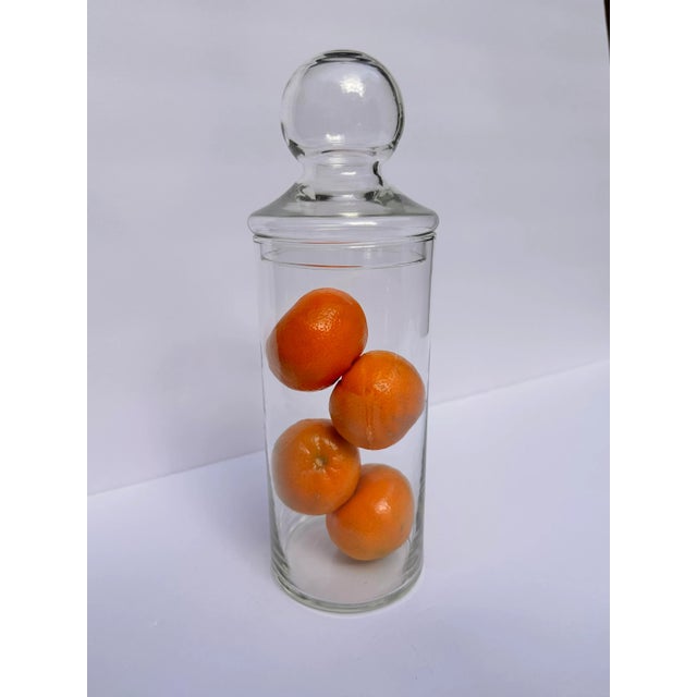 Cylinder style glass apothecary jar with detachable lid. Nice round top on this lid. Clear glass. Design decor for see-...