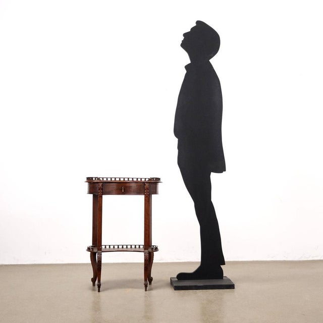 Walnut coffee table, drawer in the under-top band, gouged legs with leaf carvings, curled feet. Shelves embellished with...