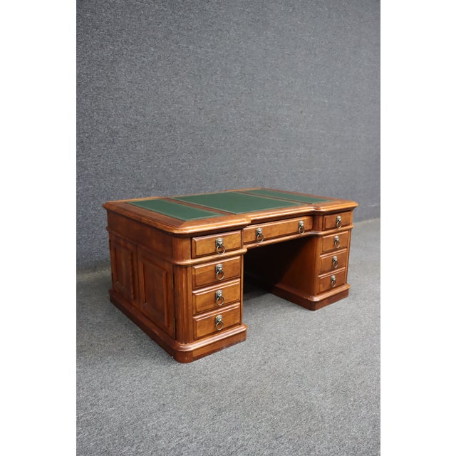 A distinctive cherry-finished coffee table modeled after a traditional partners desk. This substantial piece features a...