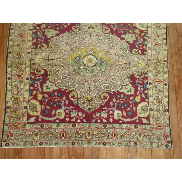 One of a kind rare original size antique Sivas rug with a raspberry colored ground and gray medallion and border with...