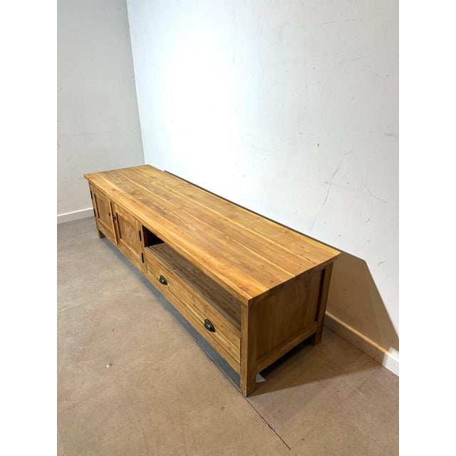 Beautiful solid teak media cabinet with a warm natural finish, combining timeless craftsmanship with practical storage....