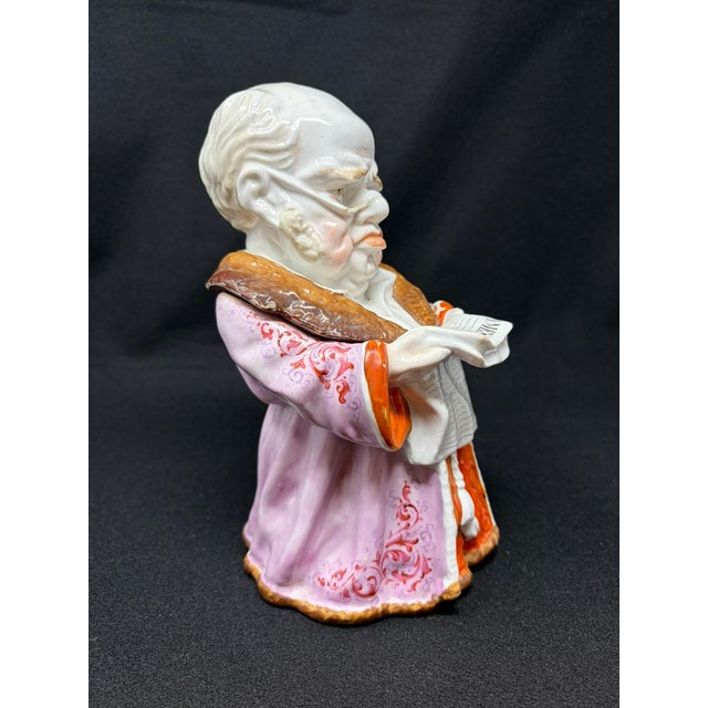 Late 19th-century Conta & Boehm "Times Newspaper" figural tobacco jar. Figure of an older man, in his dressing gown with...