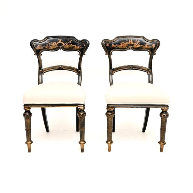 A beautiful pair of antique Victorian lacquered chinoiserie side chairs, made in England and dating from around the...