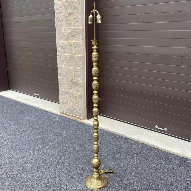 Tall, vintage, solid brass floor lamp with two bulb sockets and embossed dragon motif along the full, segmented length....