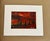 An evocative original landscape capturing the dramatic beauty of the desert at sunset. A glowing orange-red sun hangs...
