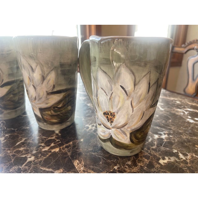 Set of Five Glazed Ceramic 'Waterloo' Mugs with handles and in pea green featuring white flowers. The mug opening is 4...