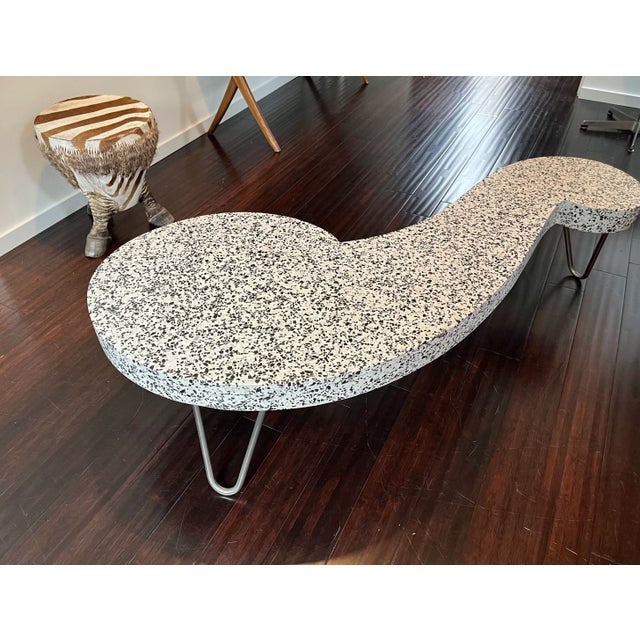 A Mid Century modern style terrazzo boomerang coffee table in the shape of a "French Curve". The table is very solid and...