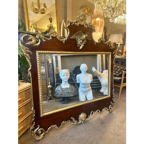 A very elaborate and decorative Regency mirror in walnut and gold gilt. with cameo sunburst and eagle pediment with...