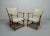 This set of four armchairs features oak frames and white leatherette upholstery. I have official proof of authenticity...