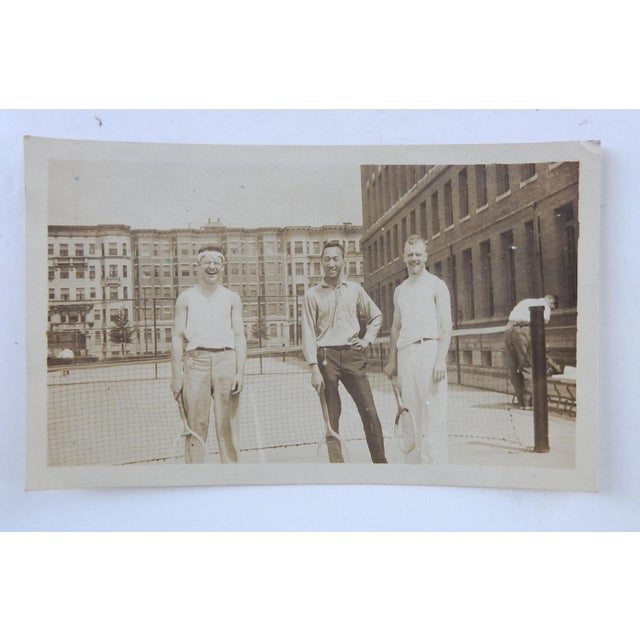 Early 20th century sepia tone snapshot photograph of 3 guys at tennis practice. Unframed.
